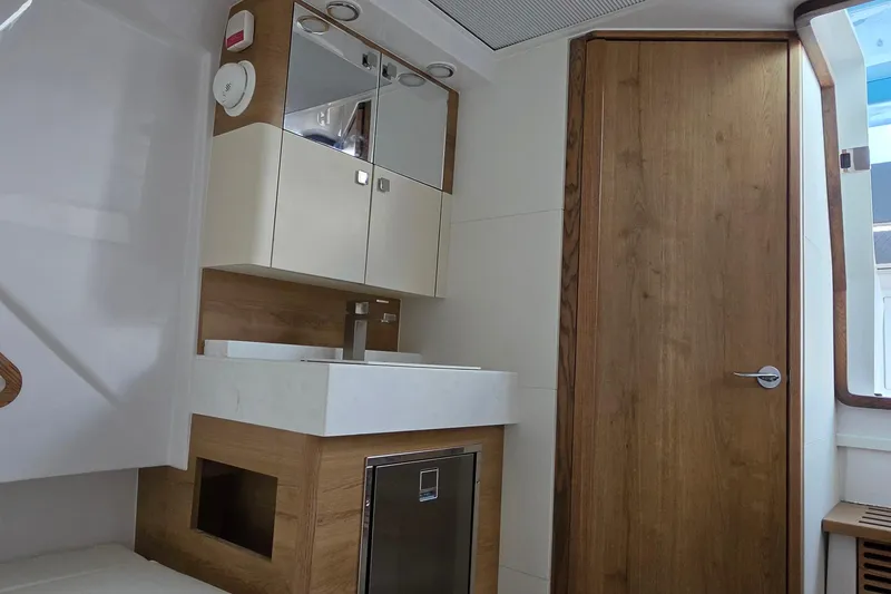 Slide: The Image of Modern bathroom interior of 2027 Bertram 39 CC yacht, featuring wood accents and sleek fixtures. - 38