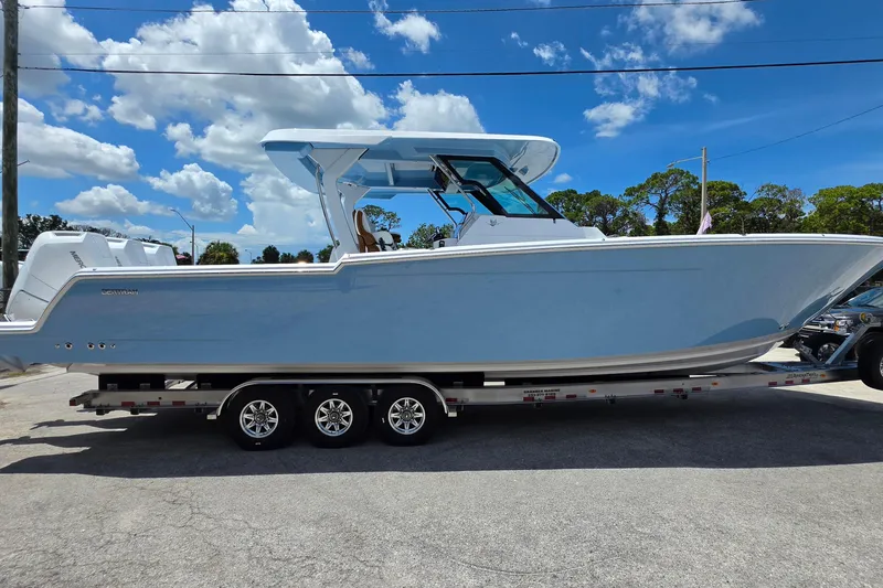 Slide: The Image of 2027 Bertram 39 CC boat on trailer under blue sky with clouds. - 6