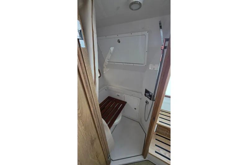 Slide: The Image of 2027 Bertram 39 CC boat bathroom with wooden accents and modern fixtures. - 40