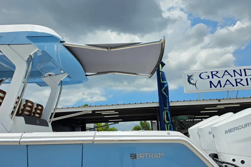 Slide: The Image of 2027 Bertram 39 CC boat with canopy at Grand Marine dealership. - 11
