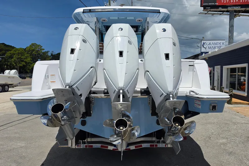 Slide: The Image of 2027 Bertram 39 CC boat with triple outboard engines, parked at a marina. - 4