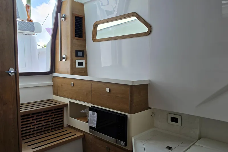Slide: The Image of Interior of 2027 Bertram 39 CC boat, featuring modern wood cabinetry and sleek design elements. - 37