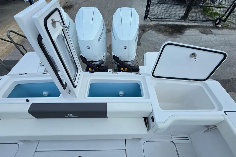 Slide: The Image of 2027 Bertram 39 CC boat with open storage compartments and dual Mercury engines. - 31