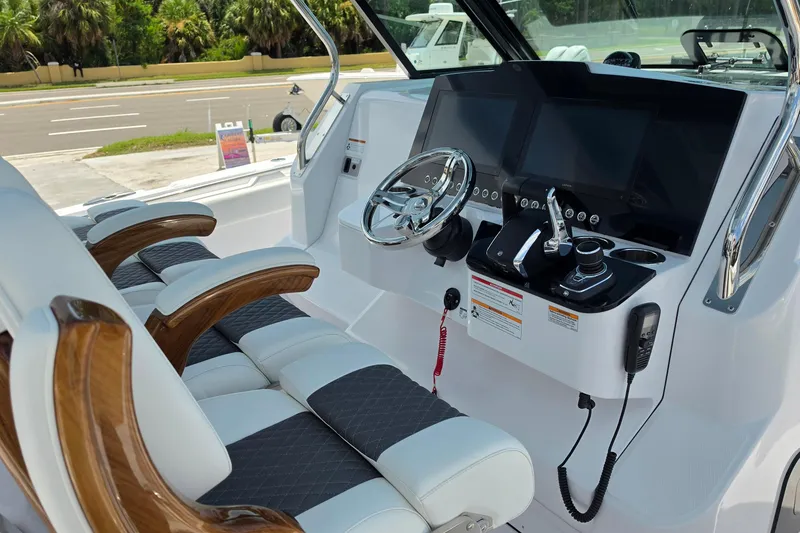 Slide: The Image of Luxury helm of 2027 Bertram 39 CC boat with modern controls and plush seating. - 16