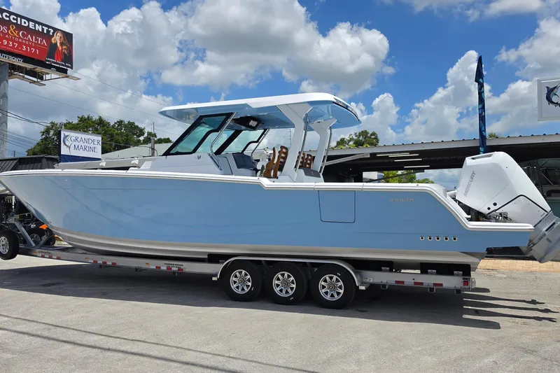 Slide: The Image of 2027 Bertram 39 CC boat on trailer under blue sky at Grander Marine. - 3