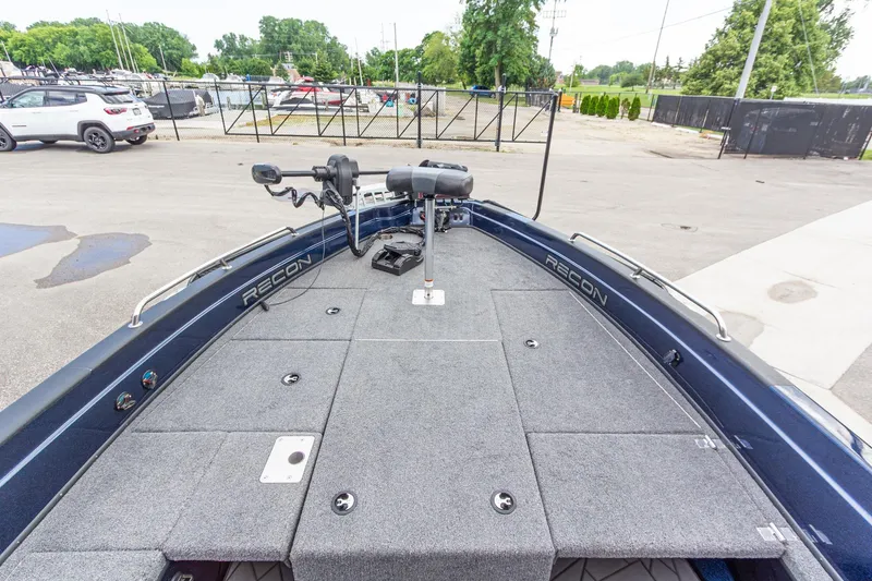 Slide: The Image of 2026 Recon 2085 T boat deck with trolling motor, parked in marina lot. - 28