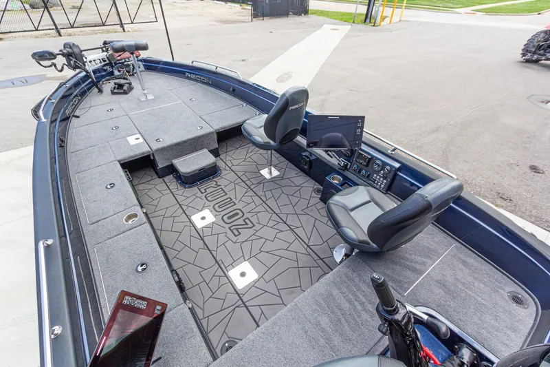 Slide: The Image of 2026 Recon 2085 T boat interior with seating, control panel, and fishing equipment. - 13
