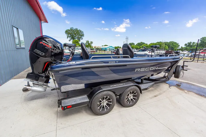 Slide: The Image of 2026 Recon 2085 T boat with Mercury engine on trailer, parked outdoors. - 3