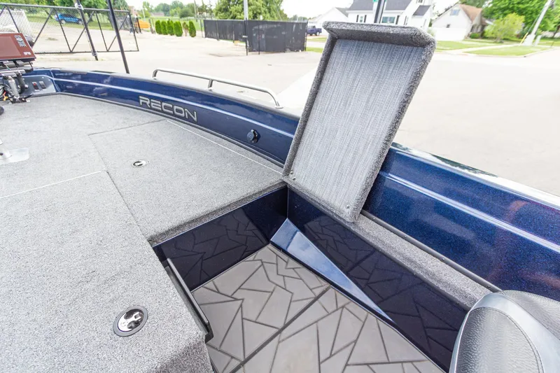 Slide: The Image of 2026 Recon 2085 T boat interior with open storage compartment, showcasing sleek design and functionality. - 26
