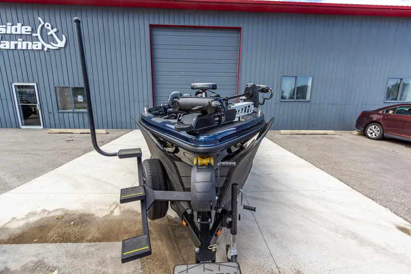 Slide: The Image of Front view of a 2026 Recon 2085 T boat on a trailer outside a marina. - 10