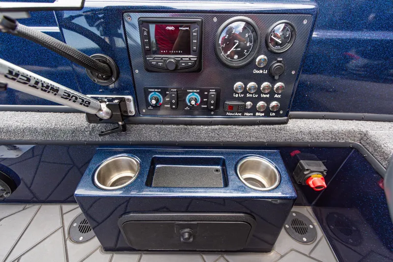 Slide: The Image of Control panel of 2026 Recon 2085 T boat with gauges, switches, and cup holders. - 19