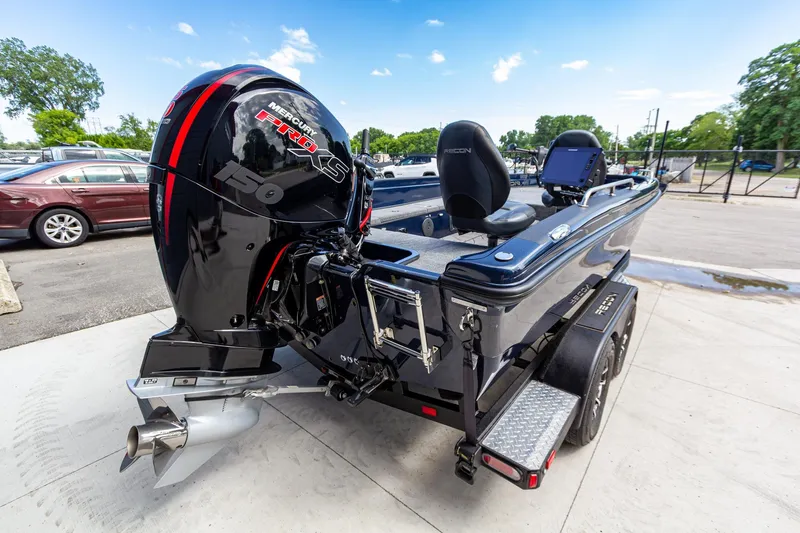 Slide: The Image of 2026 Recon 2085 T boat with Mercury Pro XS engine, parked outdoors. - 4