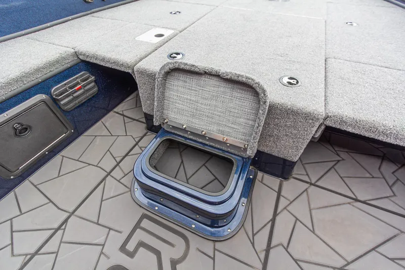 Slide: The Image of Interior view of Recon 2085 T 2026 boat with storage compartment and textured flooring. - 25
