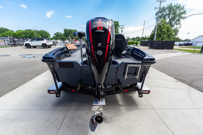 Slide: The Image of 2026 Recon 2085 T boat with powerful outboard motor, parked on concrete surface. - 5