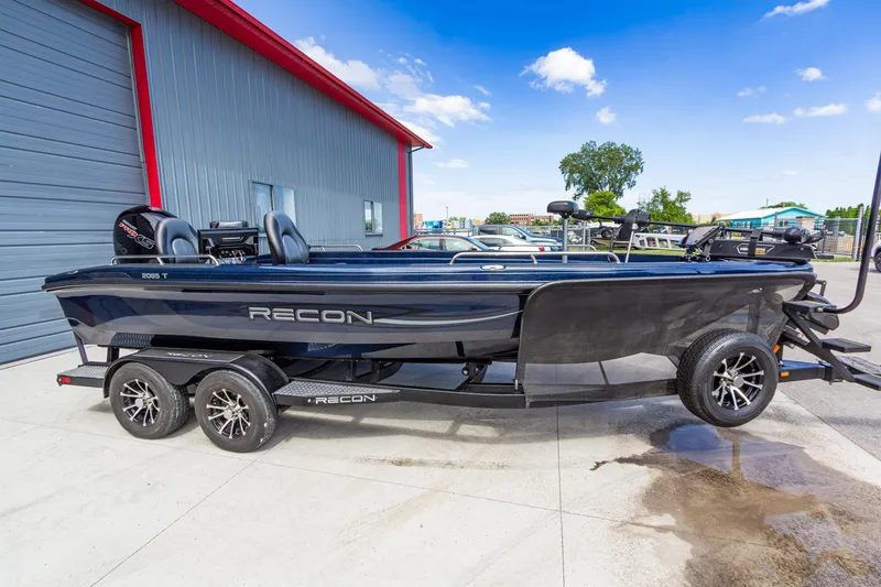 The Image of 2026 Recon 2085 T boat on trailer, parked outside a building under a clear blue sky. - 1