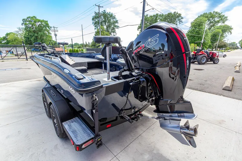 Slide: The Image of 2026 Recon 2085 T boat with powerful Mercury Pro XS engine, parked outdoors. - 6