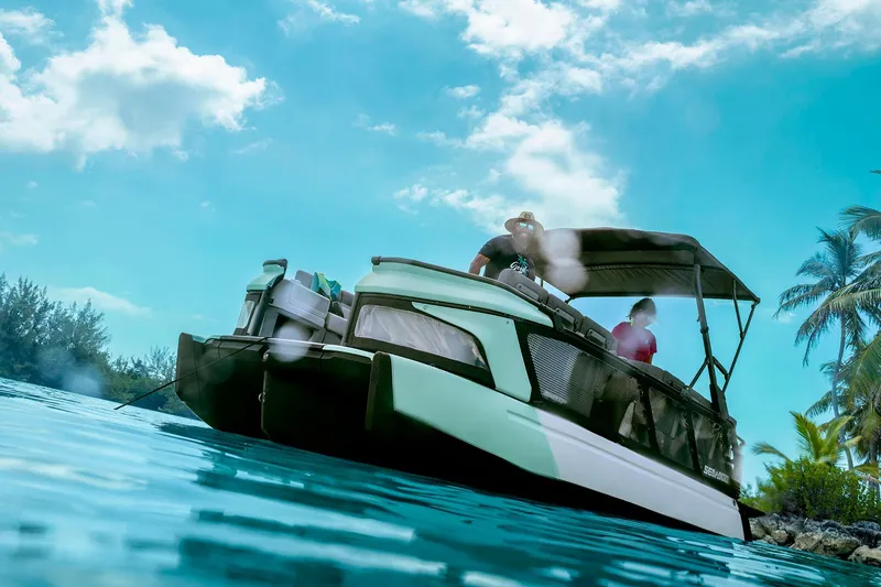 Slide: The Image of 2026 Sea-Doo Switch Cruise 21 on tropical water with palm trees and blue sky. - 5