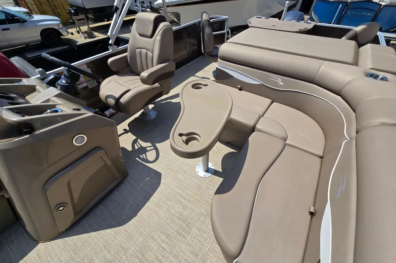 Slide: The Image of 2024 Bennington S22 boat interior with beige seating and captain's chair. - 32