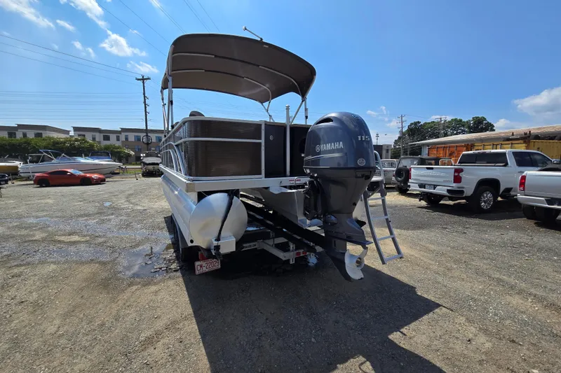 Slide: The Image of 2024 Bennington S22 pontoon boat with Yamaha 115 engine in a parking lot. - 3