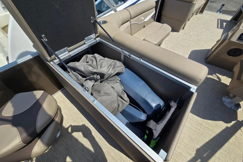 Slide: The Image of 2024 Bennington S22 boat interior storage compartment with life jackets and gear. - 18