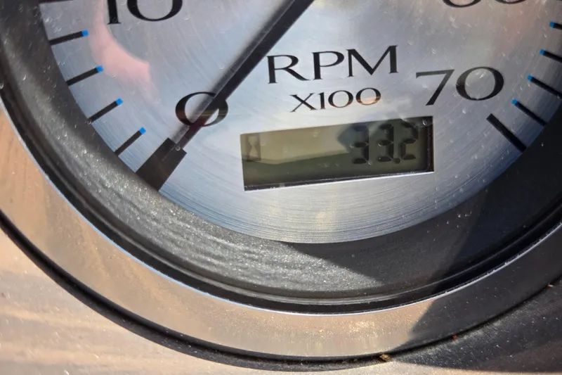 Slide: The Image of Close-up of 2024 Bennington S22 RPM gauge displaying 33.2 x 100 RPM. - 35