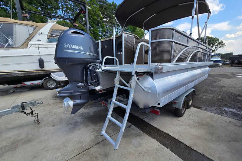 Slide: The Image of 2024 Bennington S22 pontoon boat with Yamaha outboard motor on trailer. - 7