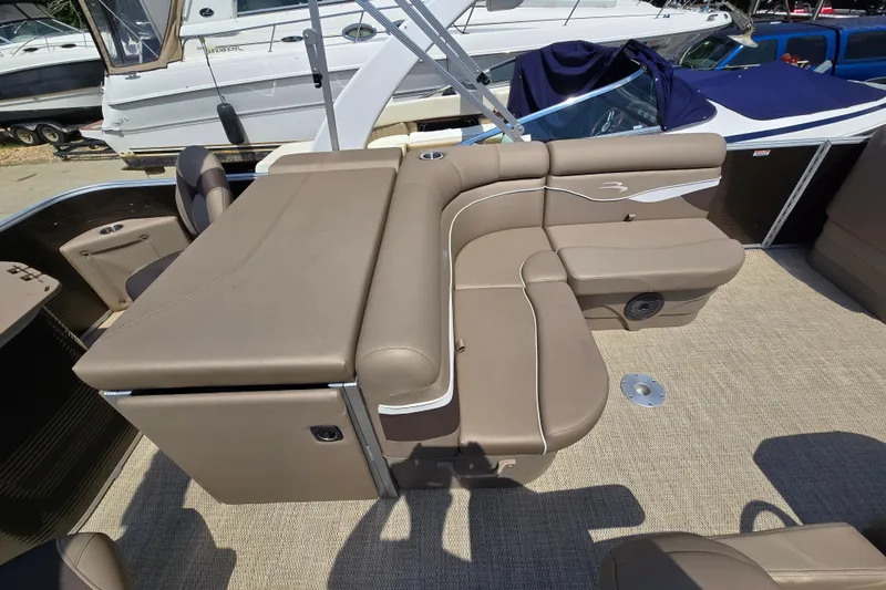 Slide: The Image of 2024 Bennington S22 boat interior with beige seating and modern design. - 23