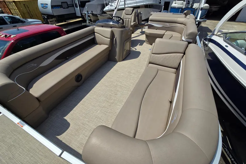 Slide: The Image of 2024 Bennington S22 pontoon boat interior with luxurious beige seating and spacious layout. - 28