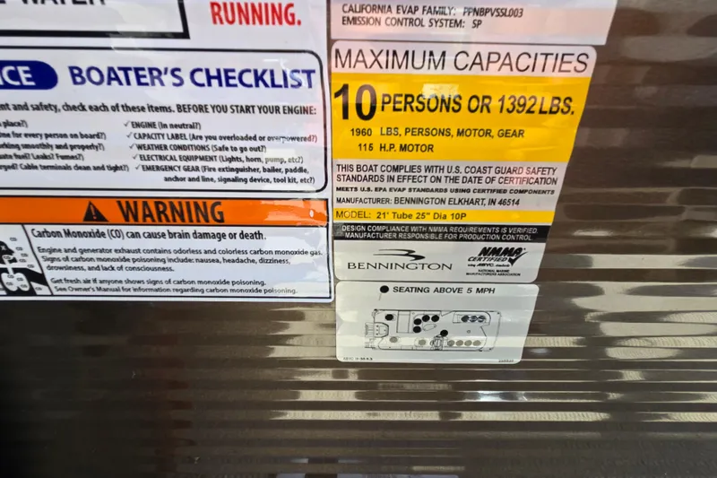 Slide: The Image of 2024 Bennington S22 capacity label, warning, and boater's checklist on metallic surface. - 38