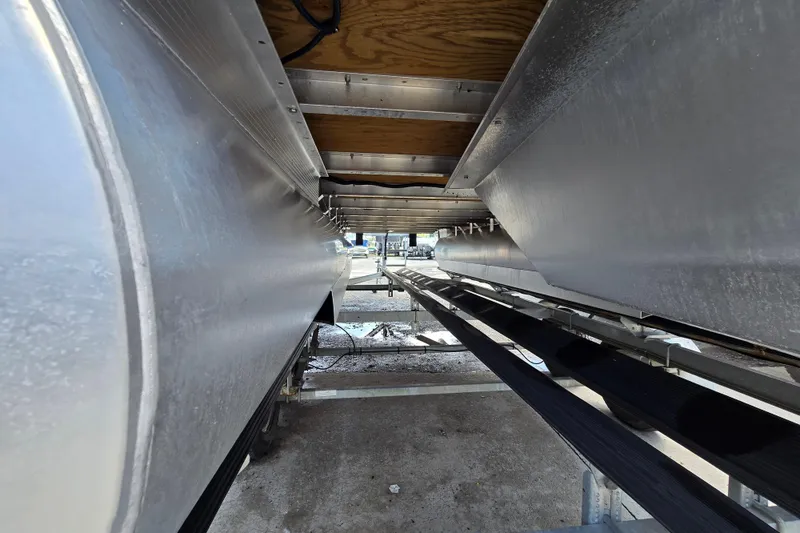 Slide: The Image of Underneath view of a 2024 Bennington S22 pontoon boat on a trailer. - 11
