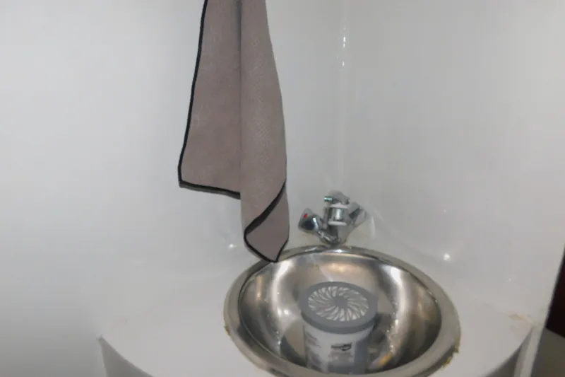 Slide: The Image of Small sink with faucet and towel in 1999 Michael Fitz Pilothouse boat. - 15