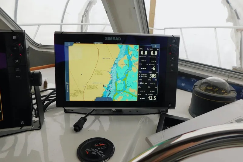 Slide: The Image of Navigation equipment on a 1999 Michael Fitz Pilothouse boat, featuring a Simrad display. - 9