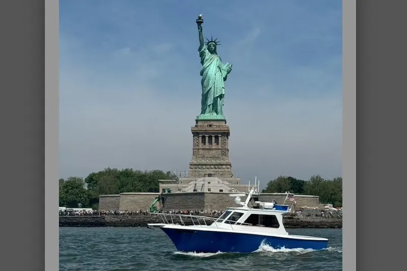 Slide: The Image of Boat cruising near Statue of Liberty, Michael Fitz Pilothouse 1999 model. - 21