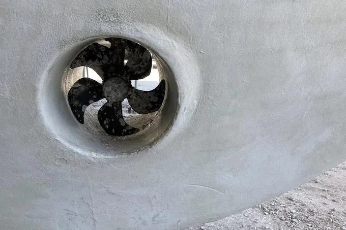 Slide: The Image of Close-up of a 1999 Michael Fitz Pilothouse boat propeller in a dry dock setting. - 20
