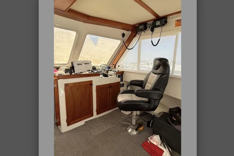 Slide: The Image of Pilothouse interior of 1999 Michael Fitz boat with captain's chair and navigation equipment. - 7
