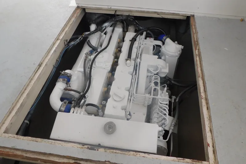 Slide: The Image of Engine compartment of a 1999 Michael Fitz Pilothouse boat, showcasing mechanical components. - 16