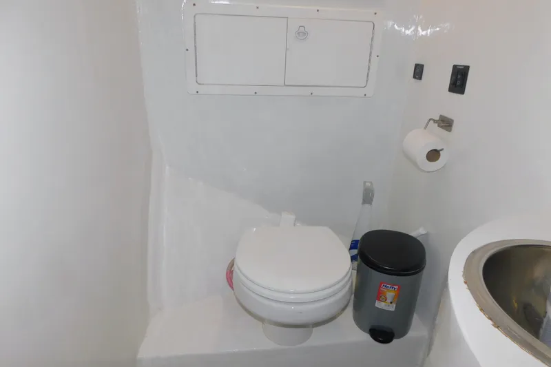 Slide: The Image of Compact bathroom in 1999 Michael Fitz Pilothouse boat with toilet, sink, and trash bin. - 14