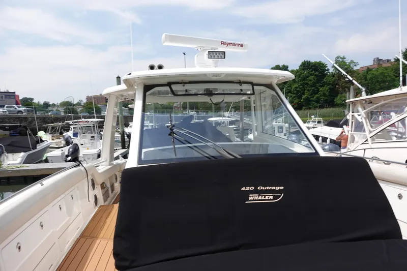 Slide: The Image of Boston Whaler 420 Outrage 2020 model docked at marina, showcasing sleek design. - 19