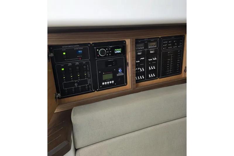 Slide: The Image of Control panel of a 2020 Boston Whaler 420 Outrage boat, featuring various switches and displays. - 31