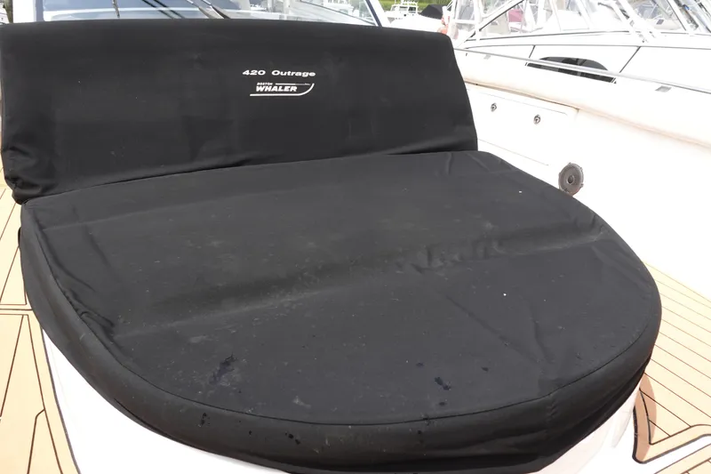 Slide: The Image of Boston Whaler 420 Outrage 2020 boat seat with black cover on deck. - 18