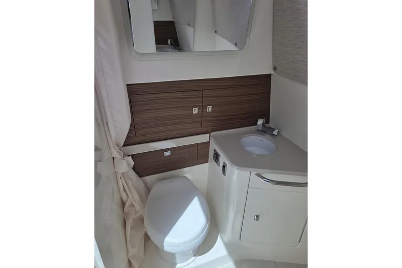 Slide: The Image of 2020 Boston Whaler 420 Outrage bathroom with modern fixtures and wood accents. - 32