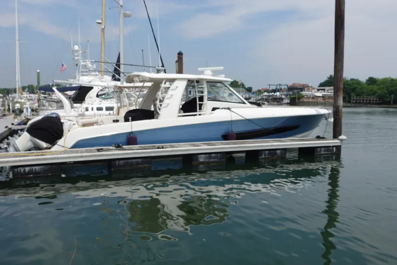 The Image of 2020 Boston Whaler 420 Outrage docked at a marina, showcasing sleek design and luxury features. - 0