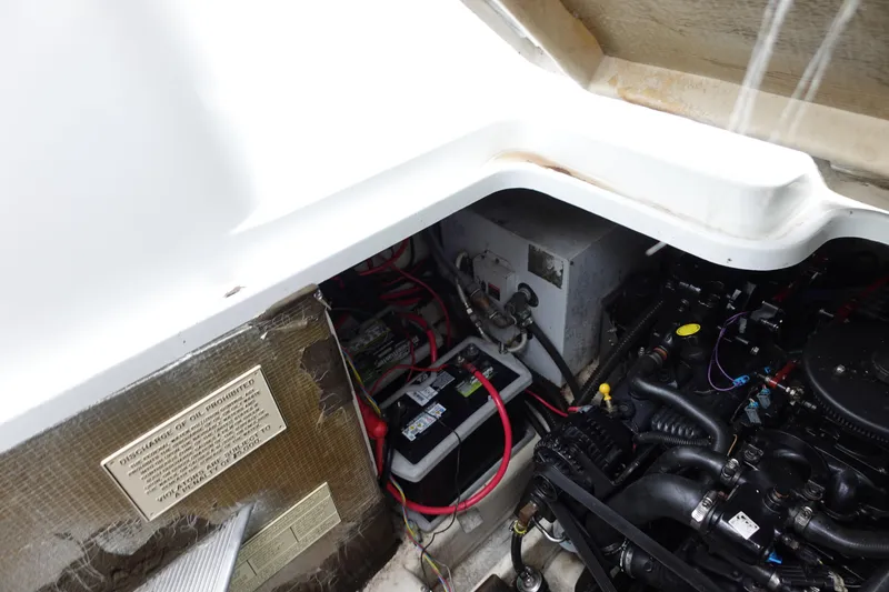 Slide: The Image of Engine compartment of a 2020 Boston Whaler 420 Outrage, showing battery and wiring. - 20