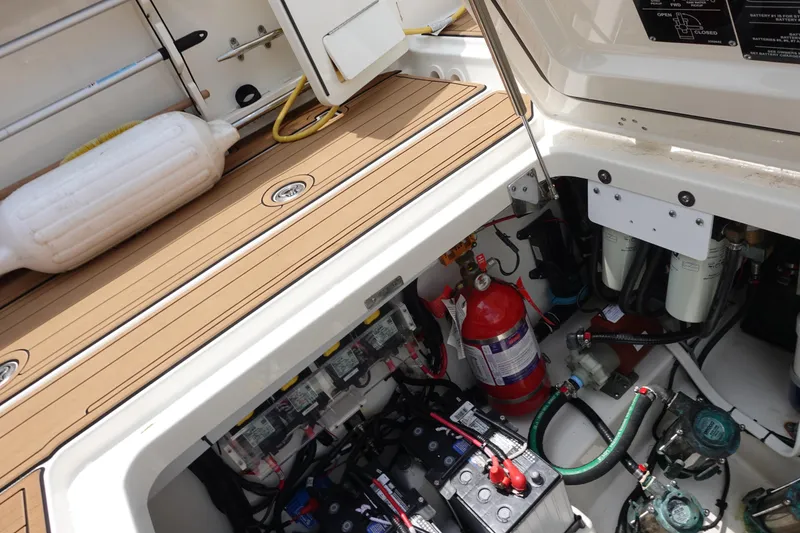 Slide: The Image of 2020 Boston Whaler 420 Outrage engine compartment with equipment and fire extinguisher. - 22