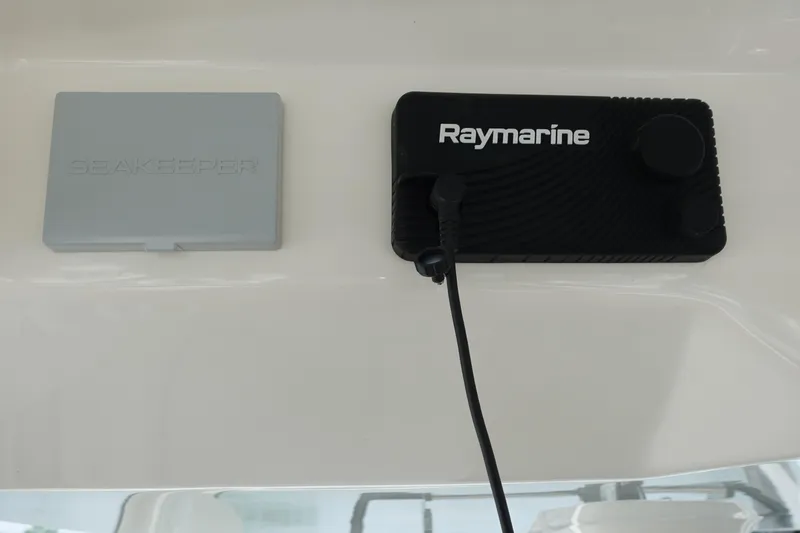 Slide: The Image of Raymarine and Seakeeper controls on 2020 Boston Whaler 420 Outrage boat dashboard. - 27