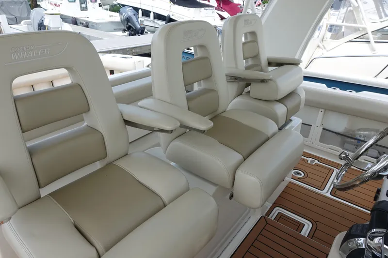 Slide: The Image of Luxury seating on a 2020 Boston Whaler 420 Outrage boat, featuring plush armchairs. - 11