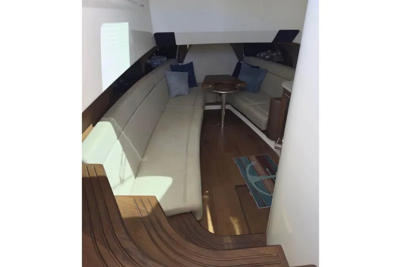 Slide: The Image of Interior of 2020 Boston Whaler 420 Outrage, featuring elegant seating and wooden flooring. - 29