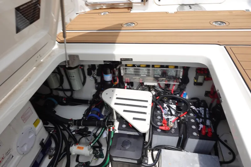 Slide: The Image of Engine compartment of a 2020 Boston Whaler 420 Outrage, showcasing batteries and wiring. - 23