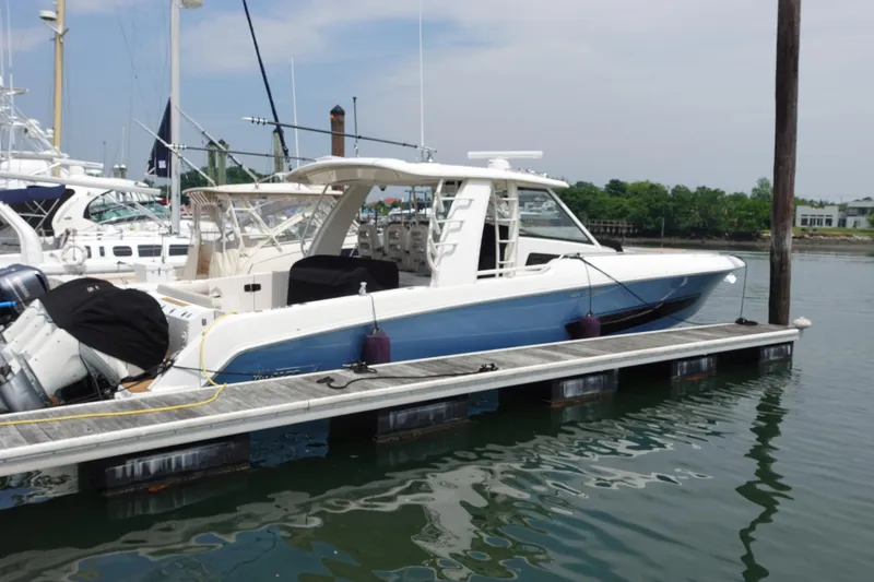 Slide: The Image of 2020 Boston Whaler 420 Outrage docked at marina, showcasing sleek design and modern features. - 3