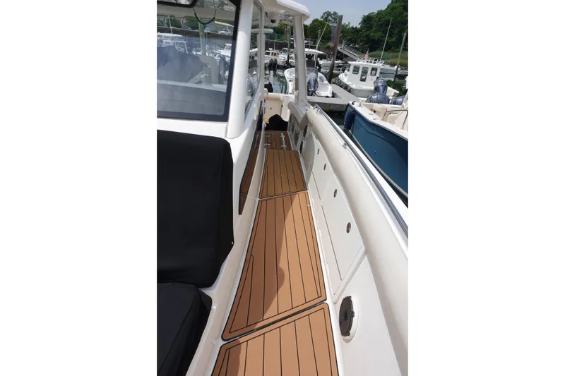 Slide: The Image of Boston Whaler 420 Outrage 2020 boat deck with teak flooring at marina. - 16